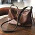 Coffee leather crossbody bag with top zipper and dark brown strap