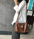 Model wearing Coffee leather shoulder bag across the body