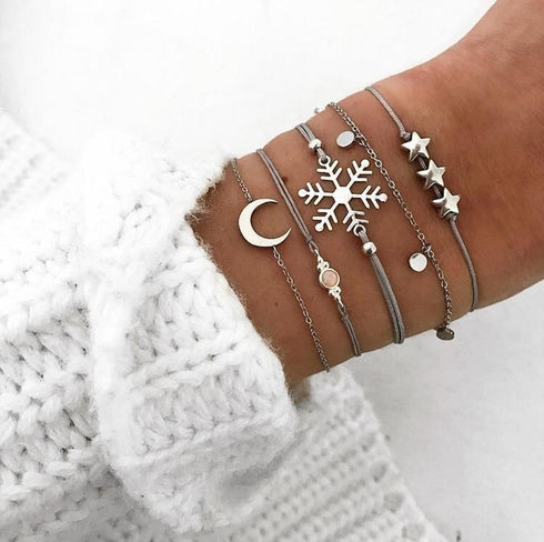 Silver-tone bracelet stack with moon, snowflake and star motifs
