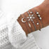 Silver-tone bracelet stack with moon, snowflake and star motifs