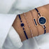Navy cord bracelets with rose-tone round and bar details, alternate wrist view