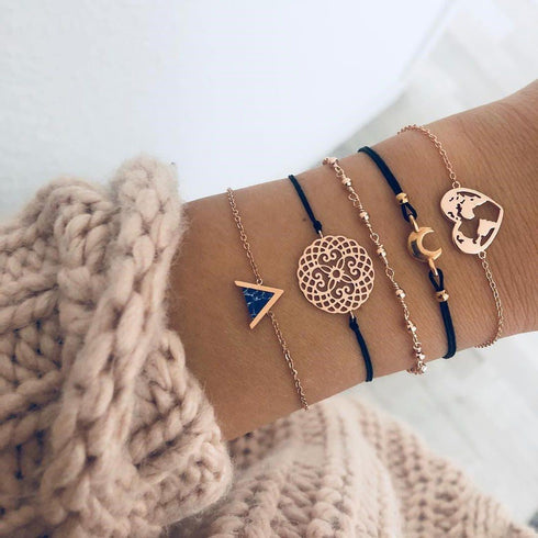 Rose-tone charm bracelets with navy accents, triangle and round openwork details