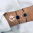 Rose-tone and navy bracelet set with large globe and dark round accents