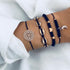 Navy beaded and cord bracelets with gold-tone shell-shaped and crescent charms