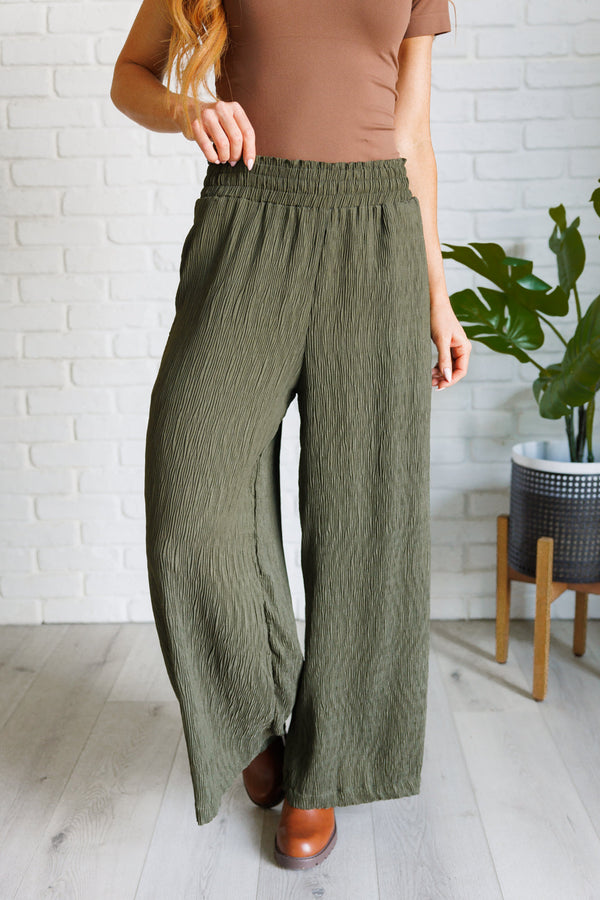 Harmony olive wide-leg pants front view showing the smocked high waist and textured fabric