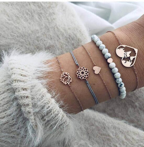 Pale blue bead bracelet stack with rose-tone globe and openwork circles