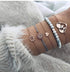 Pale blue bead bracelet stack with rose-tone globe and openwork circles