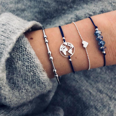 Navy and silver-tone bracelet stack with globe, heart and blue decorative beads