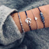 Navy and silver-tone bracelet stack with globe, heart and blue decorative beads