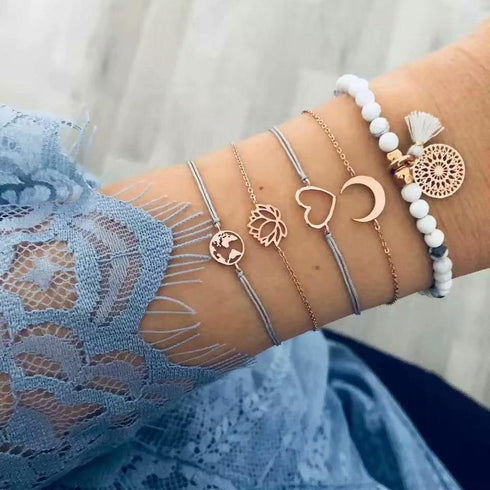 Gold-tone and pale bead bracelet stack with heart, crescent and openwork charm