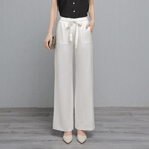 White high-waisted wide-leg pants worn with a black sleeveless top