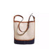 Front view of beige and navy bucket-style shoulder bag with buckle strap