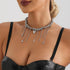 Layered dark bead necklace with assorted hanging charms, worn against black top
