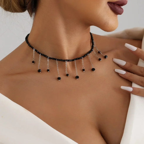 Black bead choker with multiple small black drops on fine chains, worn