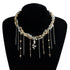 Gold-tone and silver-tone layered necklace with snake-shaped center charm, on black bust