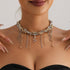 Mixed-tone beaded necklace with snake-shaped center charm, modeled