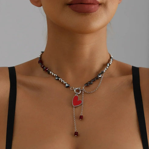 Burgundy bead necklace with red heart and long drops, modeled