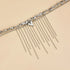 Close-up of bead strand and long hanging chain fringe on beige