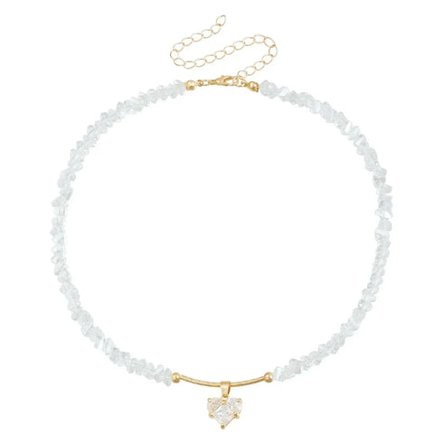 White irregular beads with pale heart pendant and gold-tone extension chain, on white