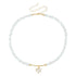 White irregular beads with pale heart pendant and gold-tone extension chain, on white