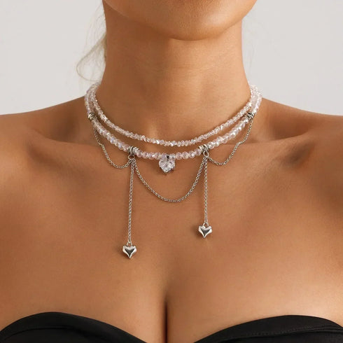 Layered silver-tone bead necklace with multiple small hearts, angled neckline view