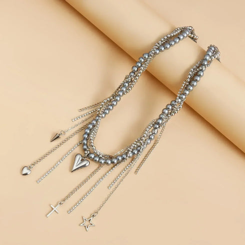 Dark bead and charm layers arranged across a beige display surface