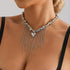 Silver-tone bead and chain-fringe necklace with pointed heart, angled close-up