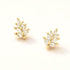 Pair of gold-dipped marquise CZ leaf stud earrings on a cream background