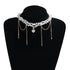 White layered bead and gold-tone chain necklace displayed on a black bust