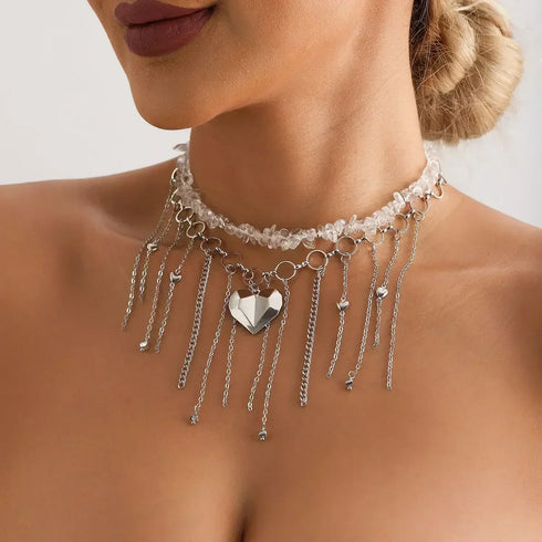 Pale beaded necklace with a large heart and long chain fringe, modeled