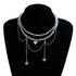 Pale layered beaded heart necklace displayed on a black bust