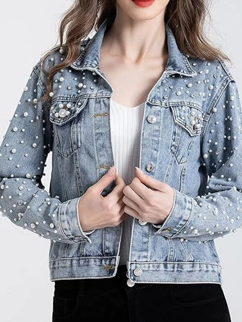 Light-blue pearl-style embellished jacket worn over a white top