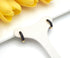 Pair of Black enamel and gold-tone hoop earrings on white