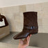 Brown retro buckle boot showing low heel and pointed toe