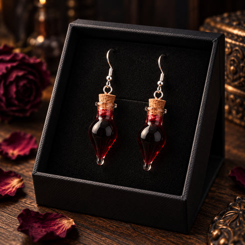 Pair of red liquid-filled vial drop earrings with silver-tone hooks; display box not included