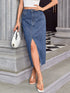 Side-front view of blue slit denim midi skirt worn with sandals