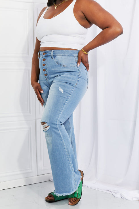 Light-blue flared jeans showing distressed knee and side fit