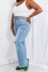 Light-blue flared jeans showing distressed knee and side fit