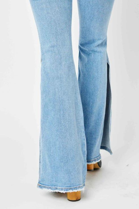 Close-up of raw slit hems on light-wash flare jeans