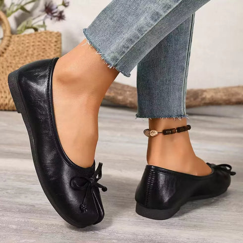 Side and rear view of black split-toe flats