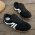 Black lace-up sneakers displayed on wooden steps