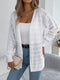 White crochet-knit cardigan, front view worn with a white top