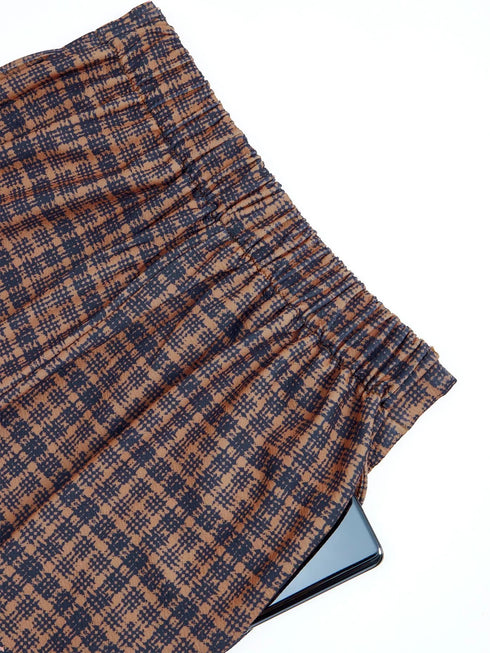 Close-up of brown plaid pants showing ruched waistband fabric