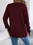 Burgundy crochet-knit cardigan, back view showing the longer hem