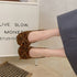 Top view of brown ballet flats with large front bows