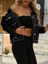 Black studded denim jacket worn off one shoulder, showing the button front and raw hem