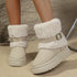 Beige round-toe platform boots worn on a model, showing plush cuffs and buckle details