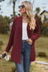 Front view of burgundy open-front cardigan with jeans