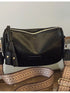Back view of black crossbody bag showing zip top and strap