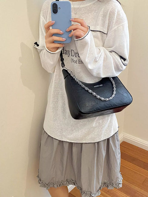 Chain-Detail Shoulder Bag: Black chain-detail bag shown in mirror photo